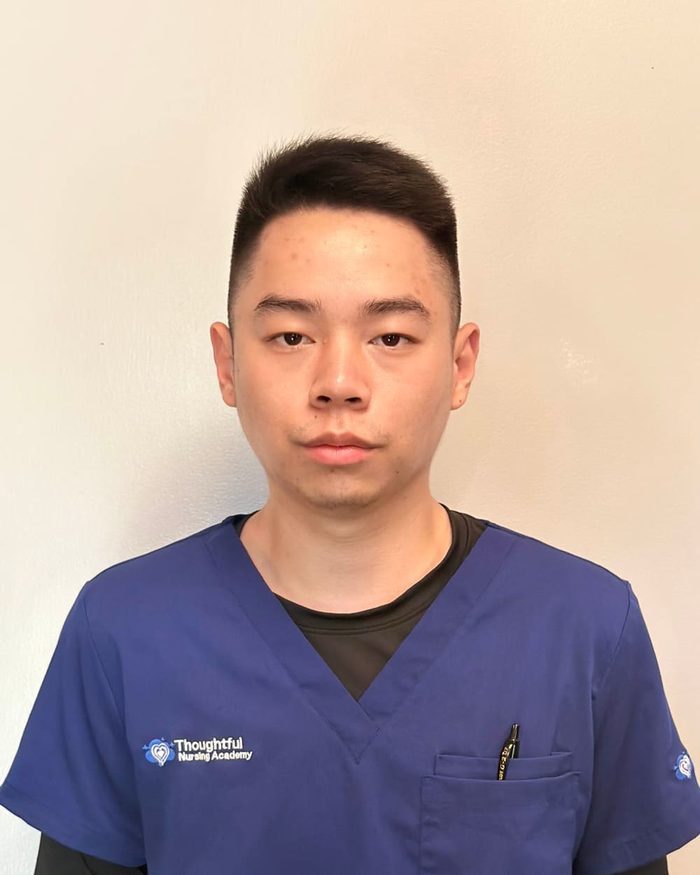 Portrait of Pierre Lam in navy scrubs.